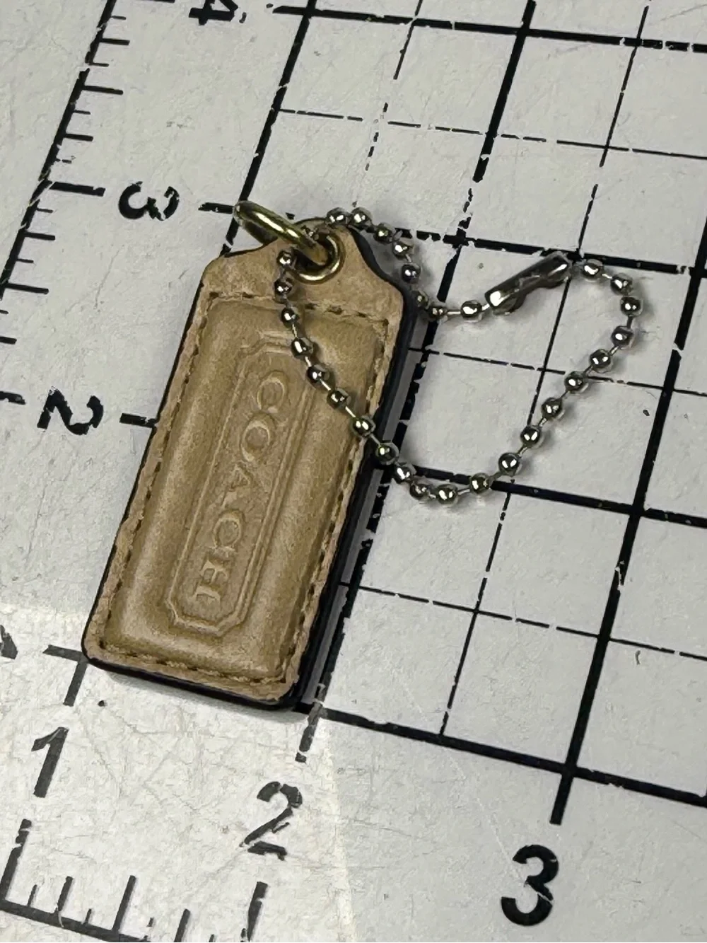 Coach two tone embossed gold front & metallic Leather back hang tag Key w Chain